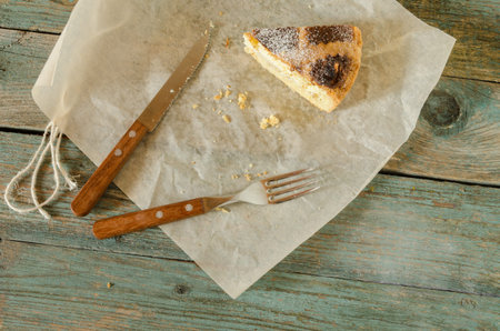 Piece of Neapolitan Easter cake on wrapping paper. Next knife and fork. Rustic style.