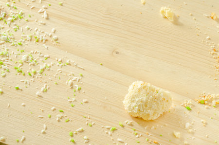 White wooden background with sugar cookie crumbs and coconut flakes Best for desing of menu, baking recipesの写真素材