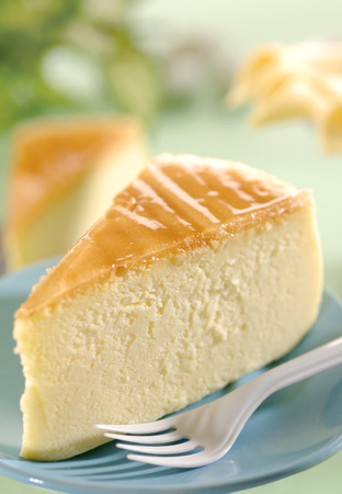 the cheese cake on blue dish with fork.の写真素材