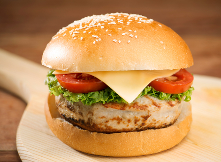 Large tasty burger with meat on wooden table.の写真素材