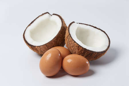 Close up of a coconut and egg on white backgroundの写真素材