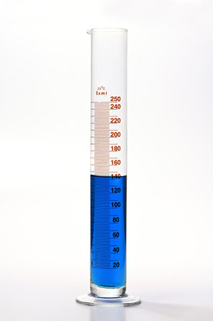 Measuring cylinders with blue liquid chemical on white backgroundの写真素材
