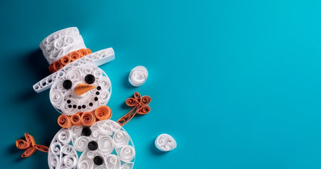 Banner with white quilling snowman closeup on blue background, top view. Merry Christmas and Happy New Year holiday concept.の素材
