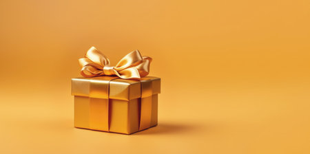 Banner with gold gift box with golden satin ribbon and bow isolated on yellow background.Holiday gift with Birthday or Christmas present,flat lay, top view,happy mother day copy space.Generated by AI.の素材