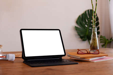 blank screen Modern laptop computer with plant pot ,headphones and notebook on wood table in office view backgroundsの写真素材