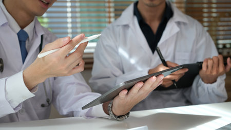 Two doctor Orthopedists meeting at workplace.の写真素材