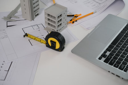 Architectural, contractors, laptop designers, sketches, blueprints and construction workspace for architectural buildings..の写真素材