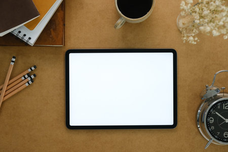 Top view of blank screen tablet on working desk.の写真素材
