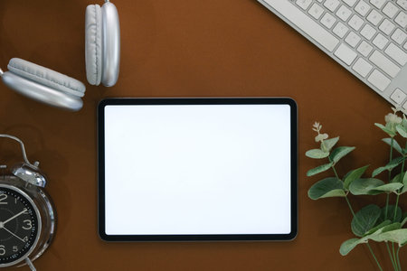 Top view of blank screen tablet on working desk.
