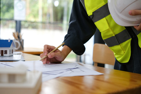 Engineer working on table and explain to customers.の写真素材