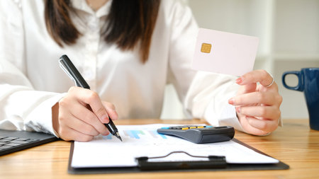 Woman's Hands using credit card for shopping online.