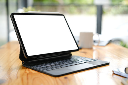Portable computer, blank screen on desk.の写真素材