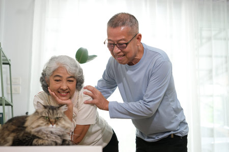 Cheerful senior couple with their cat.