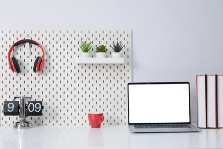 Laptop with blank white screen on office desk.の写真素材