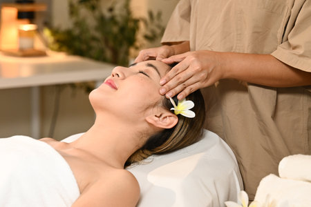Beautiful Asian woman getting a face massage at the spa.の写真素材