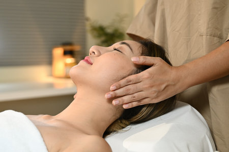 Beautiful Asian woman getting a face massage at the spa.の写真素材