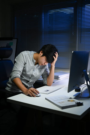 businessman working in the office in the late night during overtime period. Deadline concept.and...