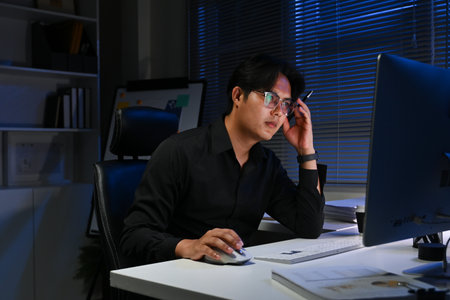 businessman working in the office in the late night during overtime period. Deadline concept.and overwork.の写真素材