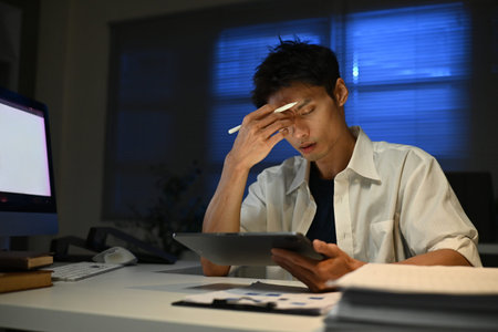 Business, night and man with stress, headache and burnout with new project, deadline and tired. Male...