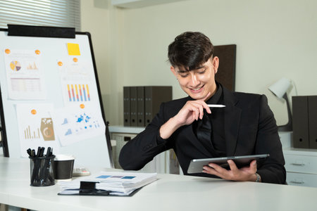 Tablet, smile and future with business man in suit at corporate office, thinking of company growth. Technology, vision or idea with happy mature employee in professional workplace for planning.の写真素材