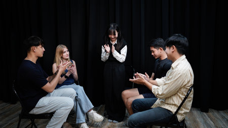 Young people clapping hands at group therapy session.の写真素材