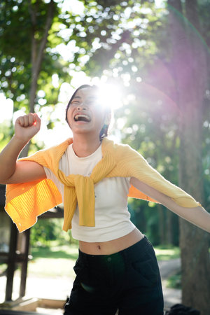 Go green culture Gen z asia people young adult woman long hair enjoy cheerful relax toothy smile happy face looking at camera nature tree public park save the earth eco friendly city life future hope.の写真素材