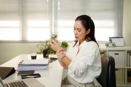 Woman have wrist pain after work hard in office feeling so pain and illness with Office syndrome symptom, healthcare office syndrome concept..の写真素材