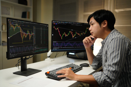 Busy business man trader broker analyst investor analyzing stock exchange trade crypto market using pc computer digital data investing finances in stock market working in dark office..の写真素材