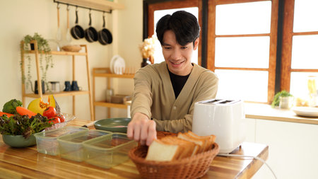 Man holding Sandwich bread slices make Sandwich for Breakfast.の写真素材