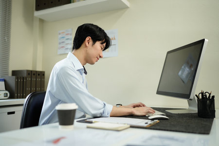 Business man, thinking and computer at desk in office for online research, reading email or report. Male entrepreneur person with internet connection for feedback, review and focus on project.の写真素材