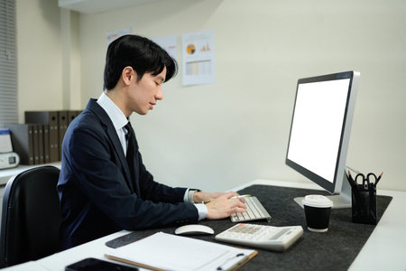 Business man, thinking and computer at desk in office for online research, reading email or report. Male entrepreneur person with internet connection for feedback, review and focus on project.の写真素材