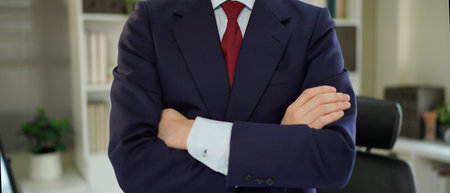 Cropped photo of successful business guy self-confident person arms crossed not smiling perfect look wear black blazer shirt tie suit costume standing office indoors.の写真素材