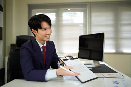 Close up of business man hands showing and pointing contract signature space in office, business deal and sign a contract agreement in the office..の写真素材