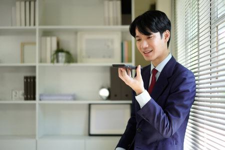 Businessperson using AI Agent virtual assistant with voice waveform interface. Concept of artificial intelligence support, voice bot, smart customer service, and virtual assistant automation..の写真素材