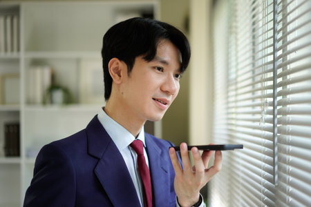 Businessperson using AI Agent virtual assistant with voice waveform interface. Concept of artificial intelligence support, voice bot, smart customer service, and virtual assistant automation..の写真素材