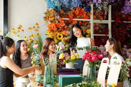 A group of women are working on a floral arrangement in flower shop. women are working together to create a beautiful display.の写真素材