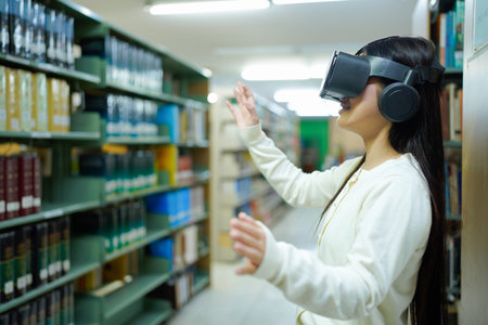 A woman wearing a white shirt is playing a video game with a virtual reality headset in library.