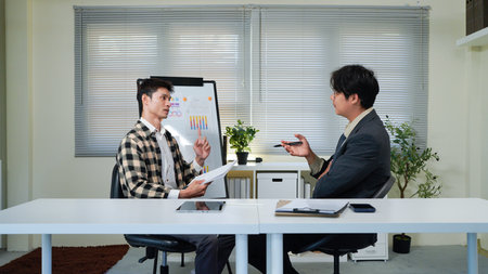 Businessmen Discussing Over Document In Office.