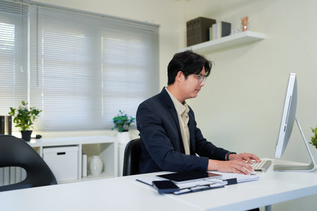 Busy financial specialist man working with finance sales document report and pc laptop computer in office. Mature executive businessman professional check analysing business, invest review.の写真素材