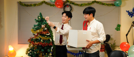 Office Christmas party: decorating Christmas tree for business holiday event.の写真素材