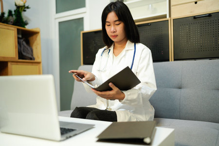 female woman doctor therapist working in office reading data.の写真素材