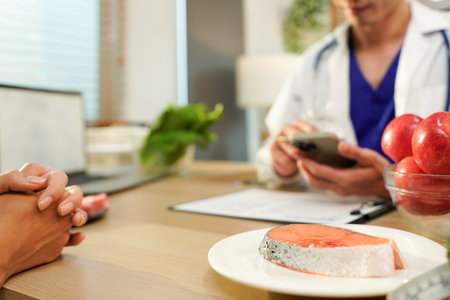 Dietician, male nutrition specialist consulting woman, developing healthy diet, dietary program. Dietary consultant asking, giving male patient advice, help, nutritional information, new meal plan.の写真素材