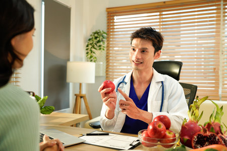 Nutritionist giving consultation to patient with healthy fruit and vegetable, Right nutrition and diet concept.の写真素材