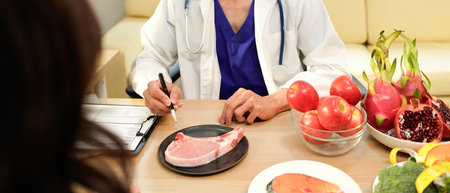 Dietician, male nutrition specialist consulting woman, developing healthy diet, dietary program. Dietary consultant asking, giving male patient advice, help, nutritional information, new meal plan.の写真素材