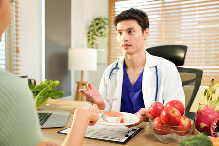 Dietician, male nutrition specialist consulting woman, developing healthy diet, dietary program. Dietary consultant asking, giving male patient advice, help, nutritional information, new meal plan.の写真素材