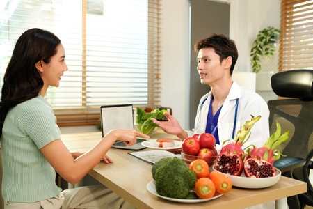 Nutritionist giving consultation to patient with healthy fruit and vegetable, Right nutrition and diet concept.の写真素材