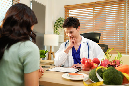 Nutritionist giving consultation to patient with healthy fruit and vegetable, Right nutrition and diet concept.の写真素材