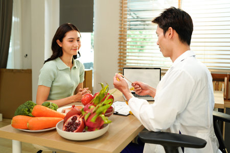 Dietician, male nutrition specialist consulting woman, developing healthy diet, dietary program. Dietary consultant asking, giving male patient advice, help, nutritional information, new meal plan.の写真素材