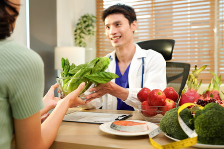 Nutritionist giving consultation to patient with healthy fruit and vegetable, Right nutrition and diet concept.の写真素材