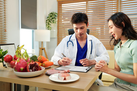 Nutritionist giving consultation to patient with healthy fruit and vegetable, Right nutrition and diet concept.の写真素材